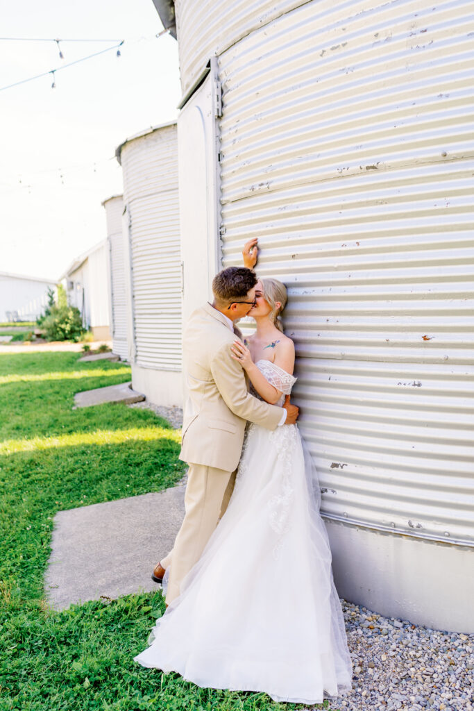 couple against silos at a farm