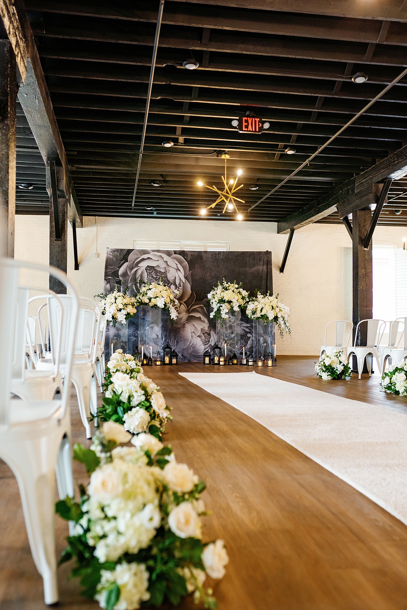 flowers line thee aisle of a wedding ceremony setup in a rustic building unique wedding venues dayton ohio