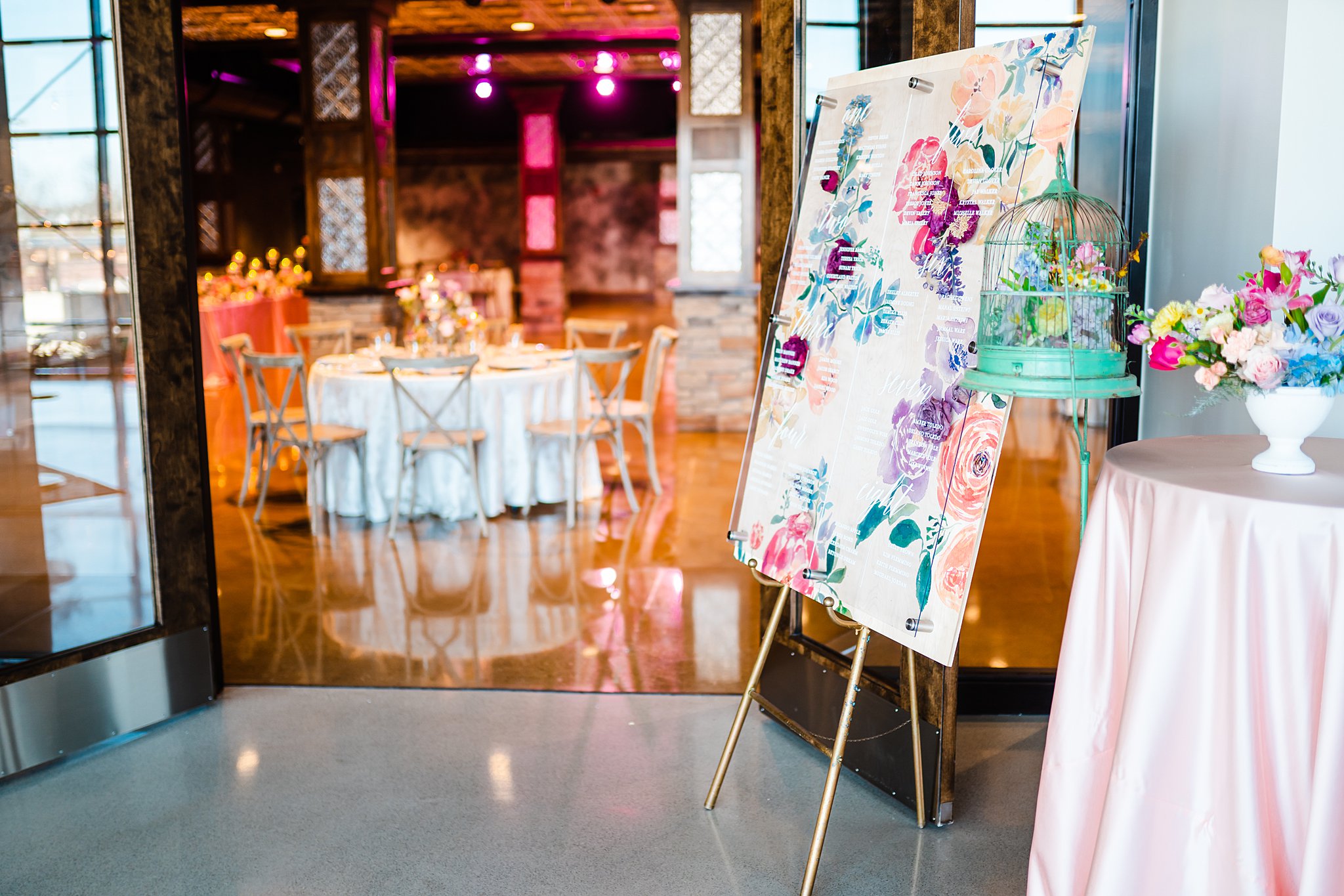 wedding reception decor set up with pink linen and multicolor flowers