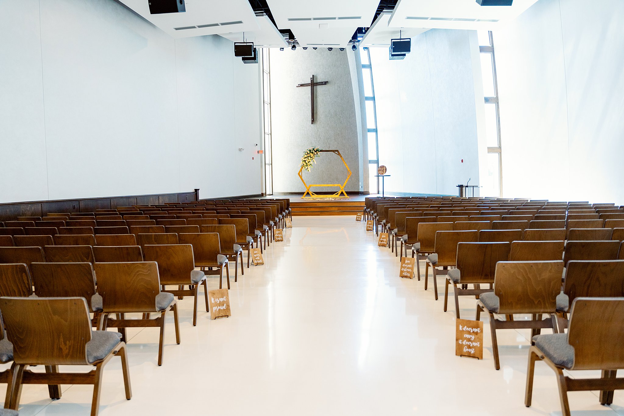 Wooden wedding arbor set up for a ceremony in a white church with wooden chairs unique wedding venues dayton ohio