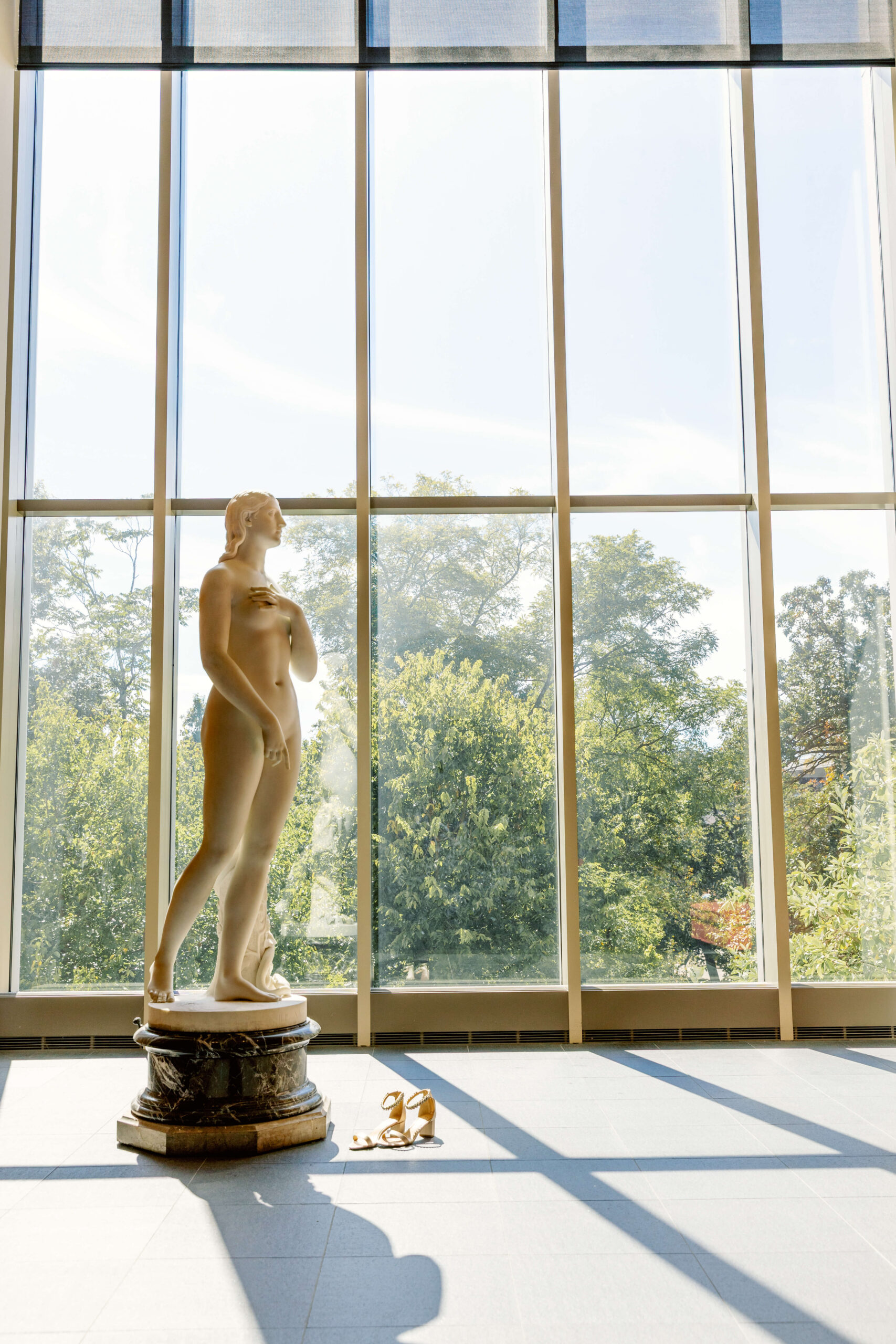 Details of a marble statue in a large glass window