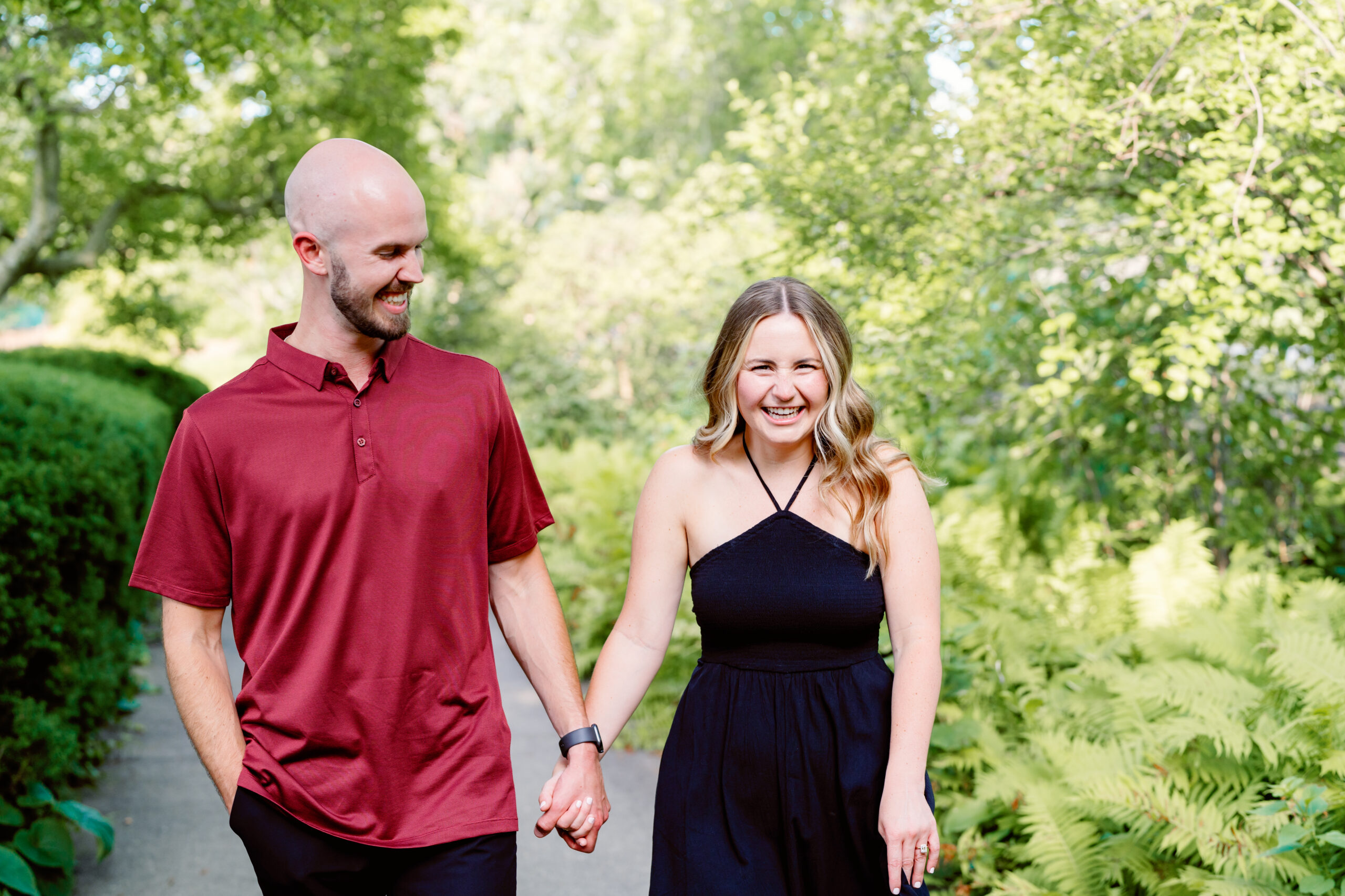 couple walking in ault park after a proposal during their engagement session 